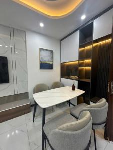 a dining room with a white table and chairs at Chung cư Tràng Duệ in An Dương
