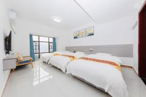 a row of beds in a room with white walls at Sky Gate Guesthouse-English Speaking Hostess, Family friendly,2-minute walk to Entrance of Tianmen Mount ,Free pick up service,Book attraction tickets, Free Laundry,Private Tour in Zhangjiajie +116 photos