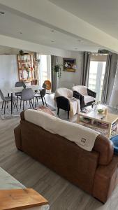a living room with a couch and a table at Hot tub Retreat, Linlithgow in Linlithgow