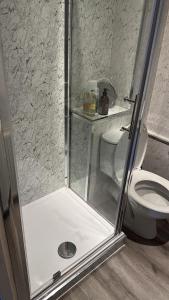a shower in a bathroom with a toilet at Hot tub Retreat, Linlithgow in Linlithgow