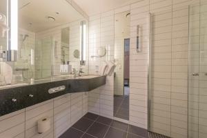 a bathroom with a sink and a large mirror at Scandic Meyergården in Mo i Rana