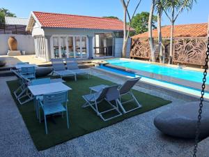 a patio with chairs and a table and a pool at San D- Lux Boutique Hotel in Durban