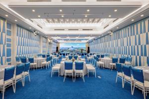 a banquet hall with tables and chairs in a room at Carmelina Beach Resort Ho Tram in Ho Tram +161 photos
