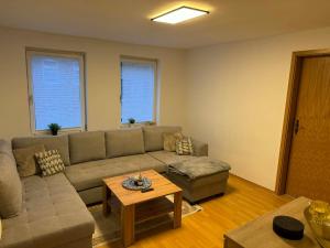 a living room with a couch and a table at Guest House Harmony in Lutherstadt Eisleben