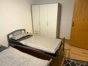 a bedroom with two beds and a closet at Guest House Harmony in Lutherstadt Eisleben