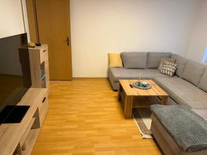 a living room with a couch and a coffee table at Guest House Harmony in Lutherstadt Eisleben
