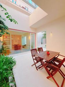 a wooden table and two chairs on a patio at Casa René - Charming apartments in Almada