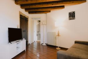 a living room with a flat screen tv and a couch at Cavour Luxury Apartments in Verona