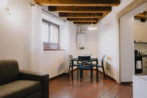 a kitchen and dining room with a table and chairs at Cavour Luxury Apartments in Verona +43 photos