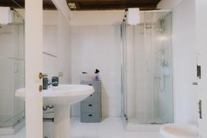 a bathroom with a sink and a shower at Cavour Luxury Apartments in Verona