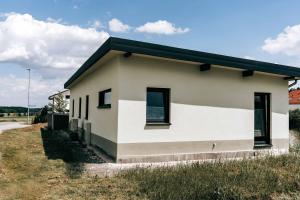 a small white house with a black roof at Seetraum Steffi in Zoznegg