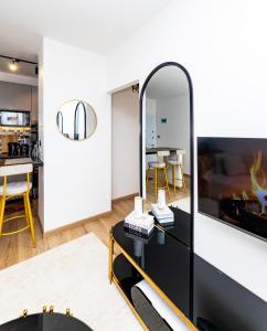 a living room with a mirror and a table at Snyder luxe homes 1 in Tatu City