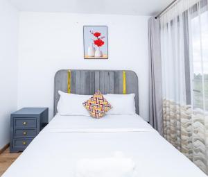 a bedroom with a white bed and a window at Snyder luxe homes 1 in Tatu City
