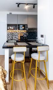 a kitchen with two stools in front of a counter at Snyder luxe homes 1 in Tatu City
