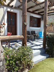 a porch with a wooden pergola and a wooden bench at Niotis Studios in Kalymnos