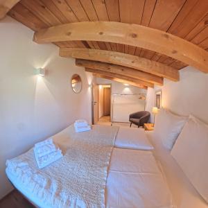 a large bed in a room with a wooden ceiling at Apartment with mountain view in Lenzerheide