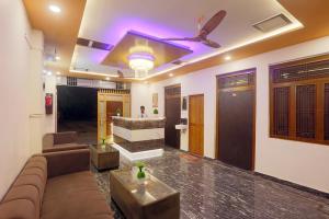 a living room with a couch and a tv at Hotel Radha Rani palace in Ayodhya