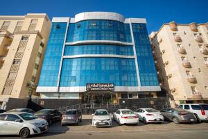 a large building with cars parked in front of it at فندق جوهرة المقام الحمراء in Jeddah