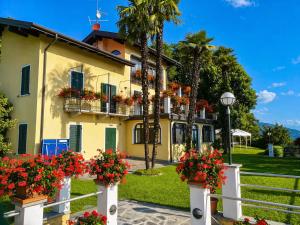 a yellow house with flowers in front of it at Villa Romilda in Arona +33 photos