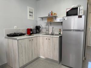 a kitchen with a refrigerator and a sink at Tête à Tête - Loft Apartment in Rhodes Town