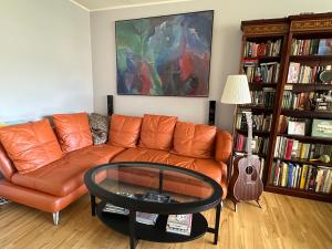 a living room with a couch and a glass table at Beach & City Fun plus Elevator & Free Parking in Hellerup +17 photos