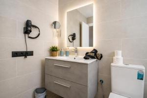 a bathroom with a sink and a mirror at Apartamento Alba Lanzarote in Puerto del Carmen +18 photos