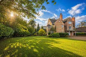 an old brick house with a large yard at The GreyStoke Mansion With Private Grounds in Hale