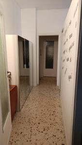 a hallway with a mirror and a hallway with doors at My tiny house in Salerno