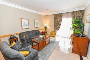 a living room with a couch and a table at Golden Carthage Hotel & Residence Tunis in Gammarth
