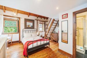 a bedroom with a bed and a staircase at Casas da Biquinha in Sintra