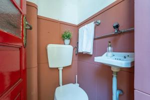 a bathroom with a toilet and a sink at Patio House - 2 Bedroom flat in Porto