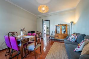 a living room with a table and a couch at Patio House - 2 Bedroom flat in Porto +13 photos
