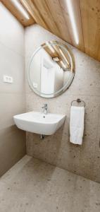 a bathroom with a sink and a mirror at Apartments and Rooms Milena in Kranjska Gora +46 photos