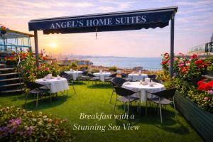 a restaurant with tables and chairs on a balcony at Angel's Home Suites - Angel Group Hotels in Istanbul