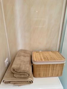 a bathroom with a basket and towels in a shower at Cozy 32 in Preiļi +8 photos