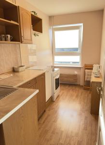 a kitchen with wooden floors and a window in it at Cozy 32 in Preiļi