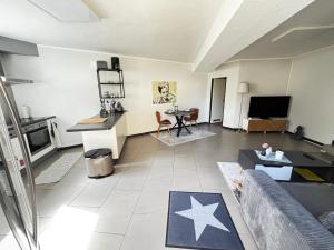 a living room with a couch and a table at Moderne und gemütliche Wohnung in Herzogenrath