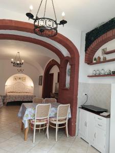 a room with a table and chairs and a bed at Il Raggio in Capri