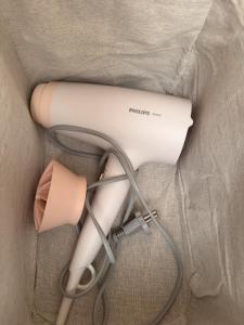 a hair dryer and a blow dryer in a bag at Cozy 32 in Preiļi