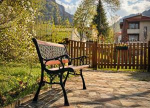 a park bench sitting on a stone walk way at Panoramic Cozy Apartment in Beli Iskar +2 photos