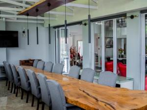 a conference room with a wooden table and chairs at San D- Lux Boutique Hotel in Durban