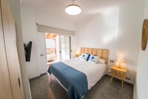 a bedroom with a large bed and a window at Sea Breeze Arguineguin in Mogán