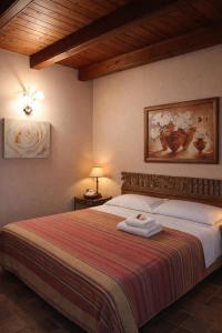 a bedroom with a large bed with a striped blanket at B&B Il Girasole in Cuneo
