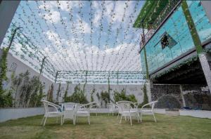 a room with chairs and a ceiling with lights at Zero Amer Royal Farm Stay in Jaipur