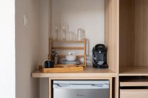 a kitchen with a wooden cabinet with a microwave at Orion 2 in Neos Marmaras
