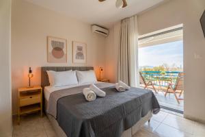 a bedroom with a bed with towels on it at Orion 2 in Neos Marmaras