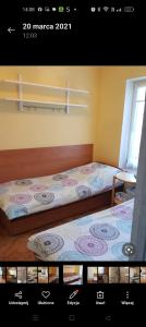 two beds sitting next to each other in a room at Pokój 2-osobowy in Węgorzewo
