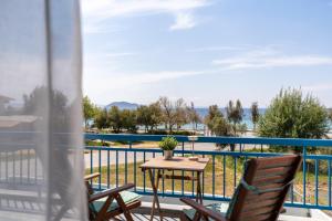 a patio with a table and chairs on a balcony at Orion 2 in Neos Marmaras