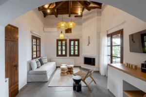 a living room with a couch and a table at Tilia Resort in Mouresi