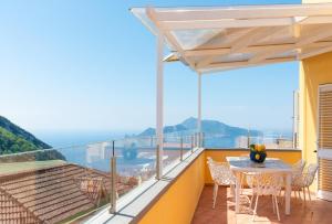 a balcony with a table and chairs and a view of the ocean at Relais Miramar in Termini